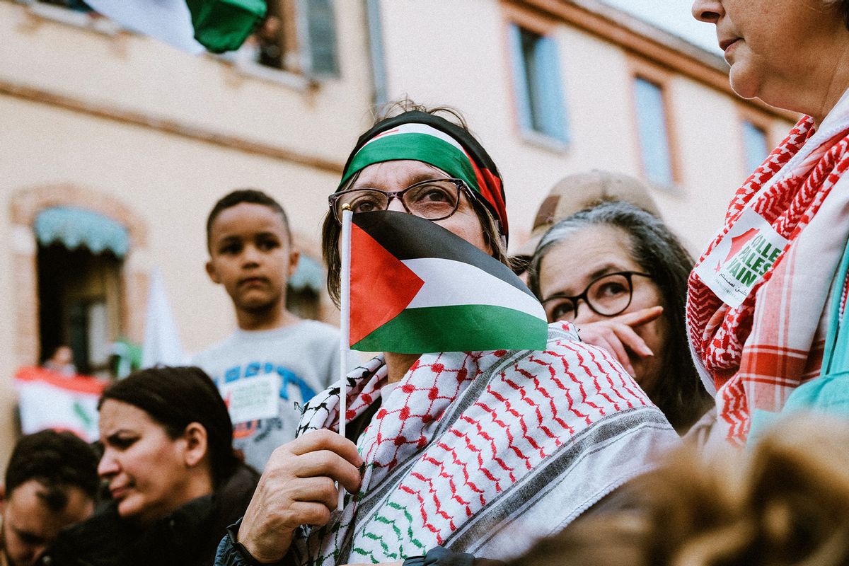 Portrait of a woman with keffiyeh and face masked by a small Palestinian flag during a demonstration to denounce the IDF attacks on the Rafah refugee camps and in support of the Palestinians in the Gaza Strip in Toulouse, southwest of France, on May 29, 2024. (PAT BATARD/Hans Lucas/AFP via Getty Images)