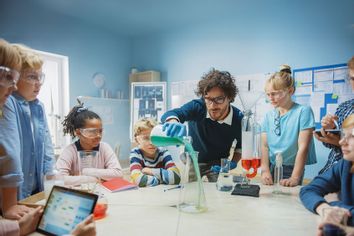 Science Teacher Shows Chemical Reaction Experiment To Children